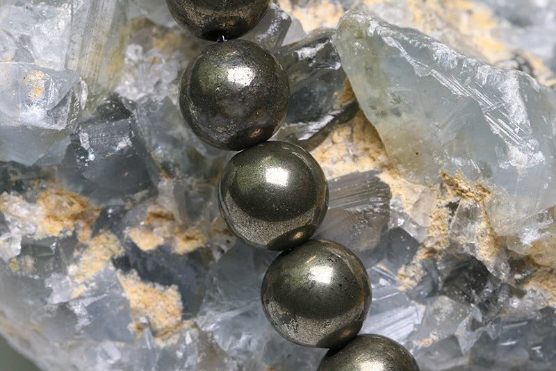 Pyrite beads on top of a crystal stone