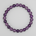 Amethyst crystal beaded bracelet on a light gray background
