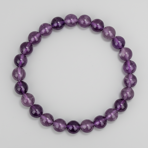 Amethyst crystal beaded bracelet on a light gray background