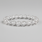 Clear quartz bracelet on a gray background