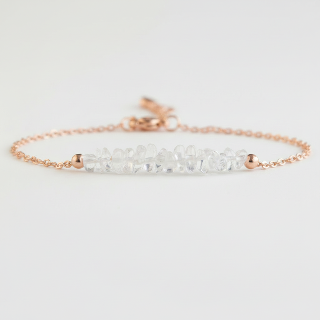 Gold tone bracelet with clear quartz on a light gray background