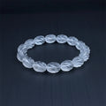 Twisting clear quartz bracelet on a dark gray background