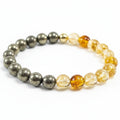 Bracelet with alternating pyrite and yellow crystal citrine beads on a white background