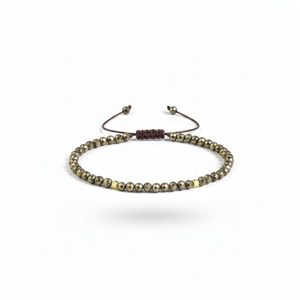Corded pyrite bracelet on a white backdrop.