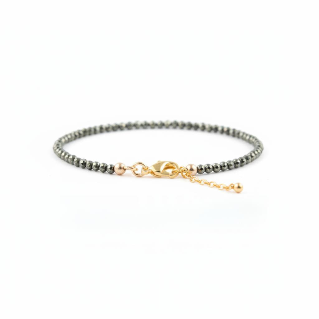 Bracelet with pyrite nugget beads and gold clasp on a white background