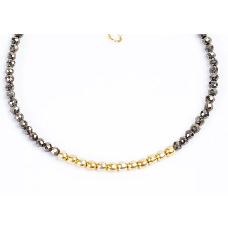 Beaded pyrite nugget bracelet with gold metal beads on white baclground.