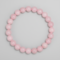 Pink beaded bracelet on a light gray background