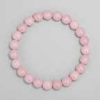 Pink beaded bracelet on a light gray background